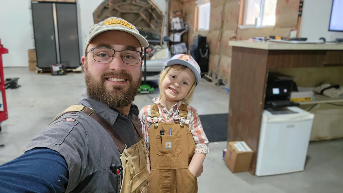 Green Light Automotive technician with a young helper inside the Rexburg shop