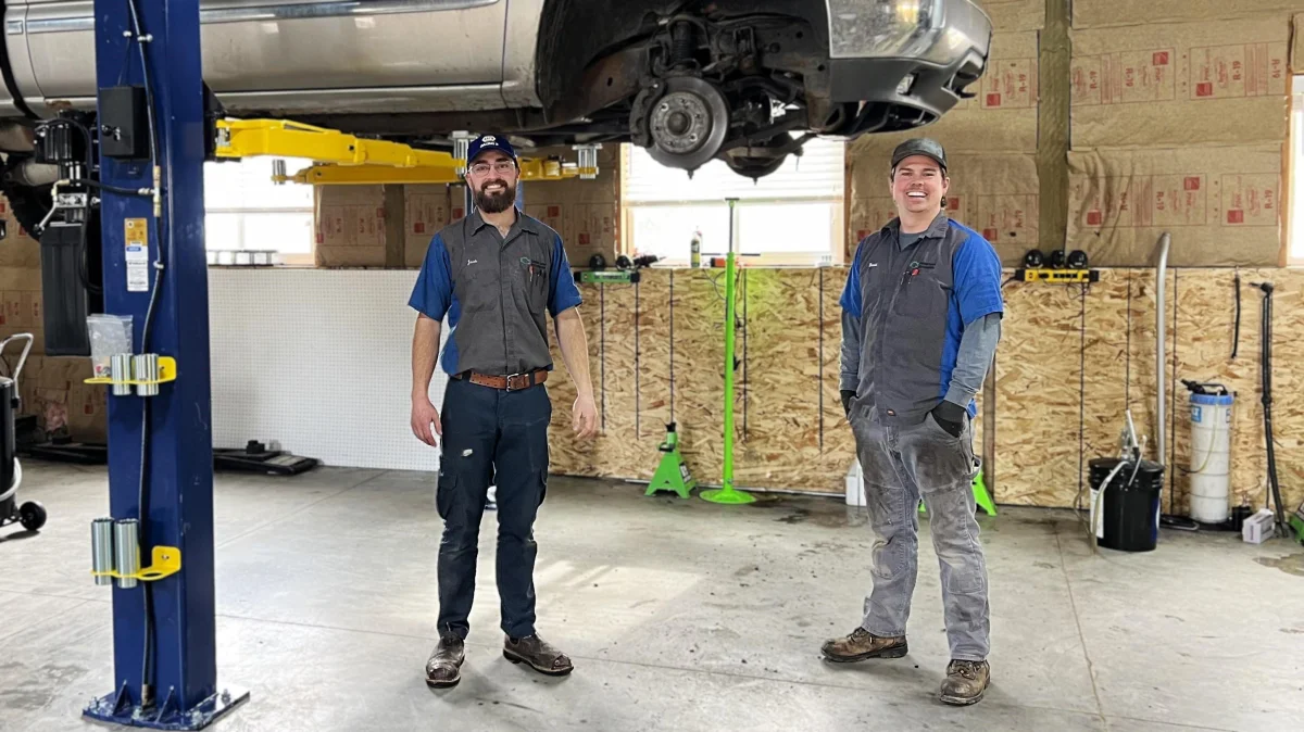 Green Light Automotive technicians in the Rexburg repair shop with a truck on a lift